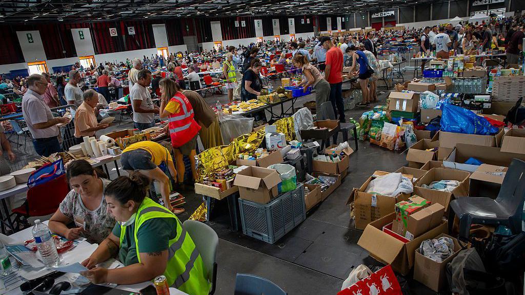 Thousands of people evacuated from their homes rest at the Bordeaux Exhibition Centre, which has been converted into a temporary emergency shelter 