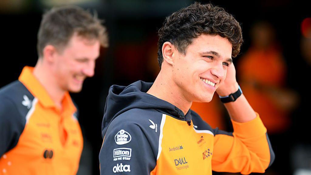 Lando Norris arrives in the paddock in Qatar