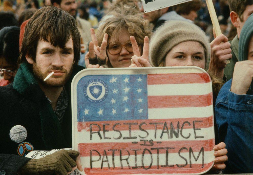 Anti-war protestors holding up a sign on a tray in the US.