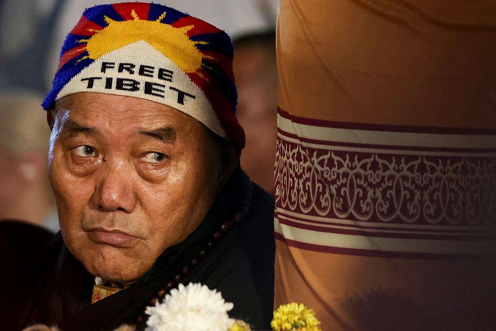 A devotee wearing 'Free Tibet' cap attends the Tibetan spiritual leader the Dalai Lama's prayer ceremony celebrating his 90th birthday at the Main Tibetan Temple in McLeod Ganj, near Dharamsala, on July 6, 2025.