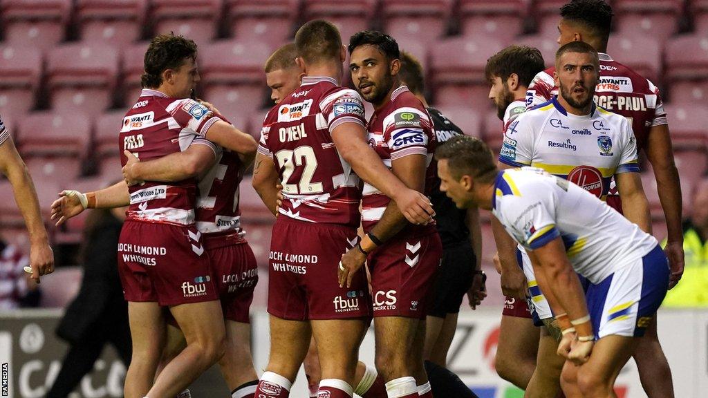 Wigan Warriors celebrate a try against Warrington Wolves