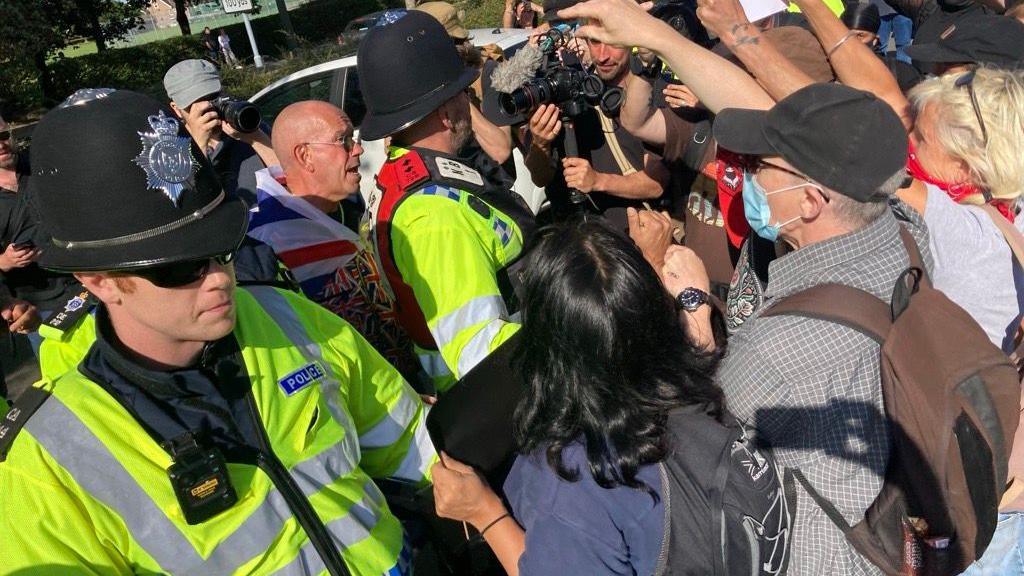 Anti-immigration protester behind police