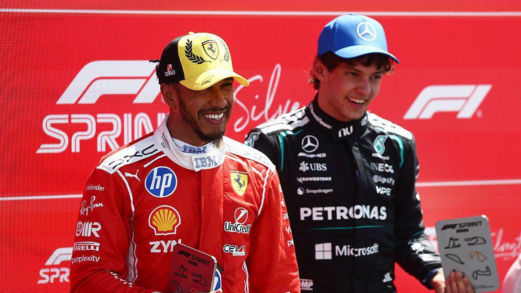Lewis Hamilton and Kimi Antonelli smile as they pose for pictures after the Silverstone sprint race in July 