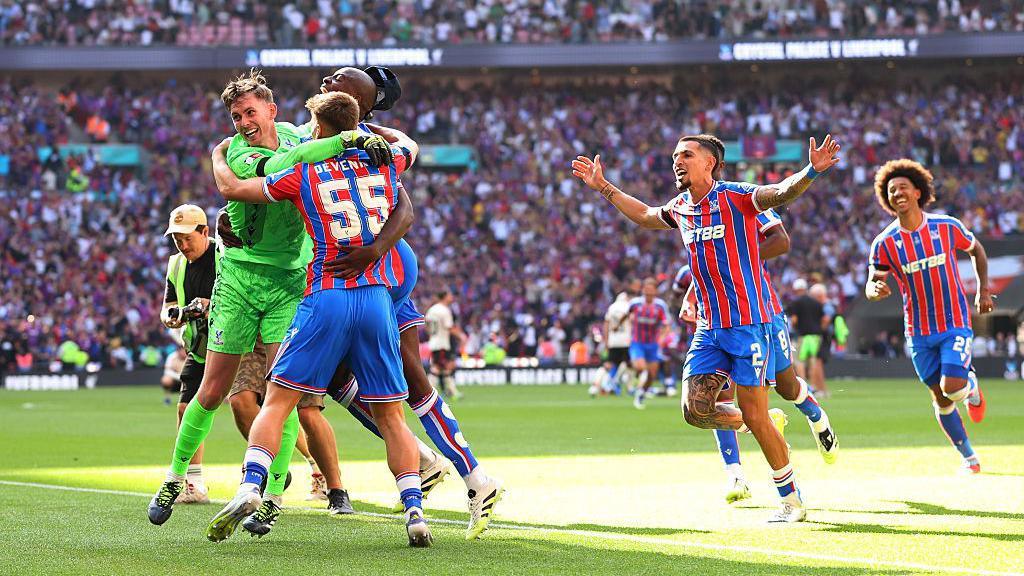 Dean Henderson celebrating with Palace players after winning the penalty shootout.
