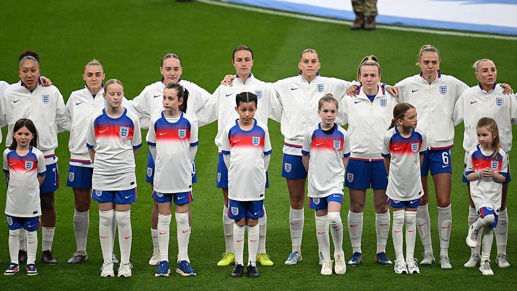 England women line up to sing the national anthem