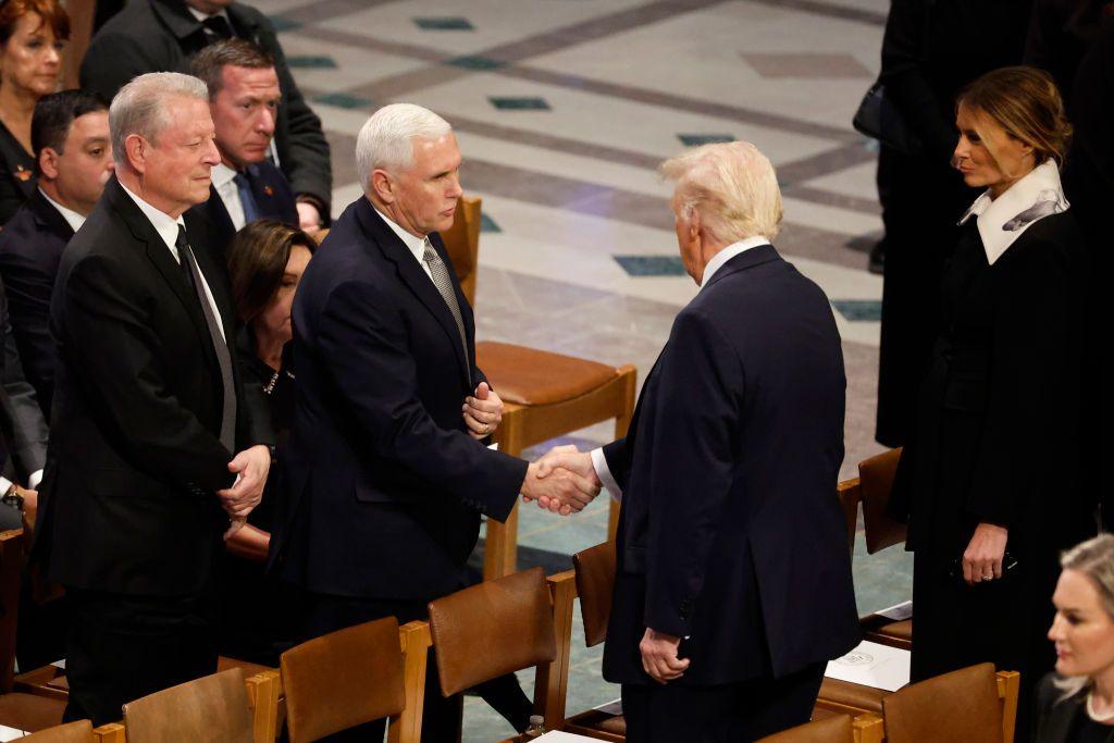 Donald Trump and his former Vice-President Mike Pence shake hands at Jimmy Carter's funeral service.