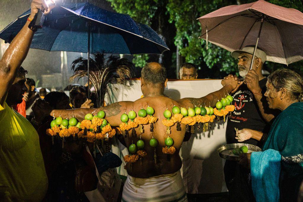 A man spreads out his arms to show off the limes and flowers attached in his back for the Thaipoosam Kavady festival in Durban , South Africa - Monday 10 February 2025