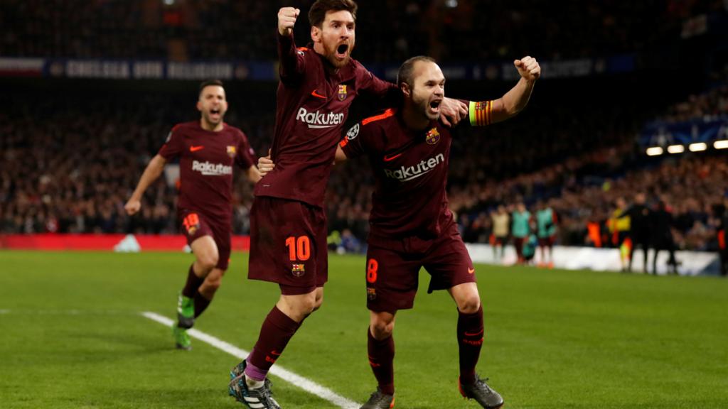 Lionel Messi celebrates scoring their first goal with Andres Iniesta