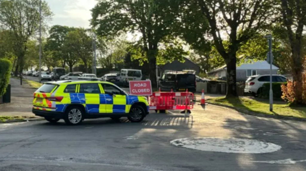 A police car in front of a road closed sign in Southway.