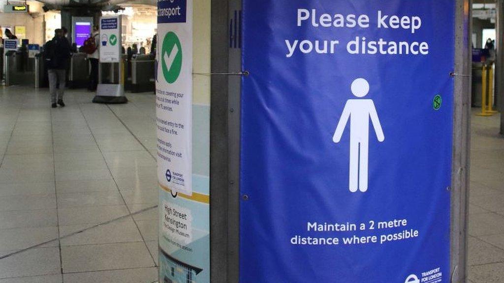 Tube station social distancing sign