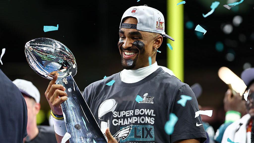 Jalen Hurts holding the Vince Lombardi trophy