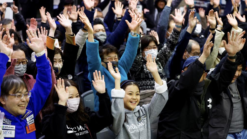 People raise their hands after a moon landing by the Smart Lander for Investigating Moon (SLIM), in a public viewing event in Japan