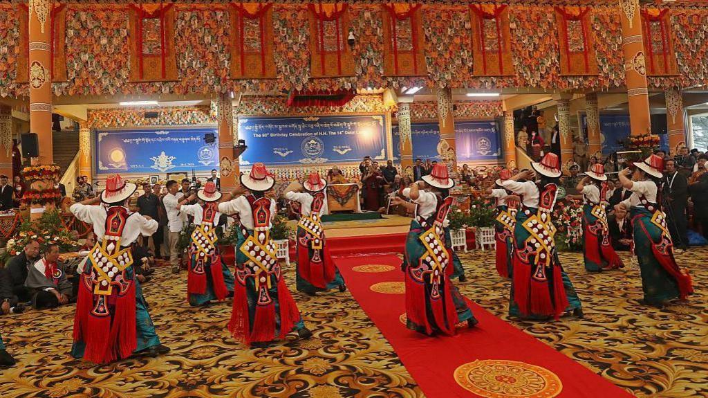 Tibetan spiritual leader the Dalai Lama (C) watches a traditional dance performance during an event held in his honour, at the Main Tibetan Temple in McLeod Ganj, near Dharamsala on June 30, 2025. 