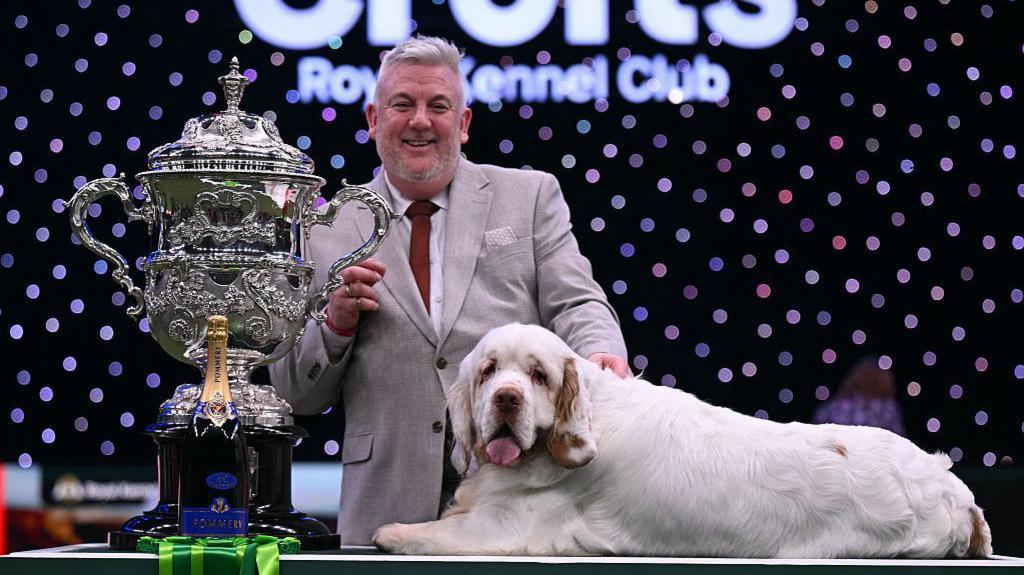 Lee cox with his Clumber spaniel named Bruin and the trophy for best in show