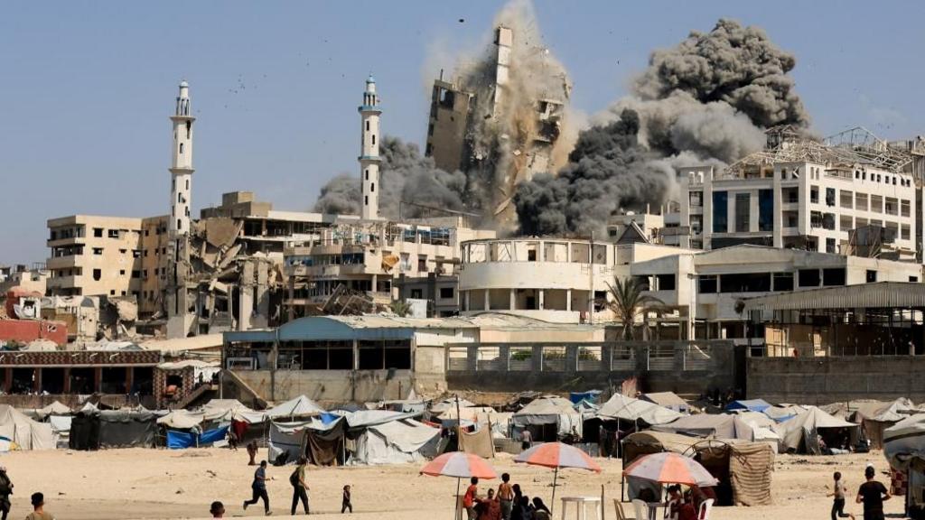 Smoke rises from the evacuated Al-Ghefari tower, as it collapses after it was hit by Israeli air strikes