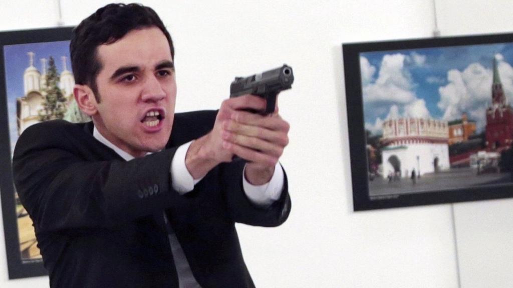 An unnamed gunman gestures after shooting the Russian Ambassador to Turkey, Andrei Karlov, at a photo gallery in Ankara