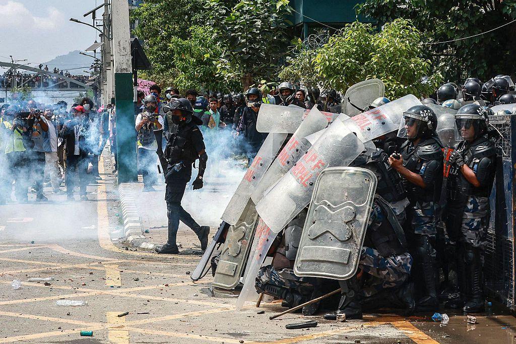 Armed Police Force (APF) personnel stand guard during a protest outside parliament