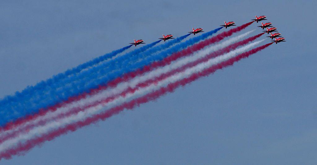 'The Red Arrows', release red, white and blue smoke as they fly over New York Harbour.