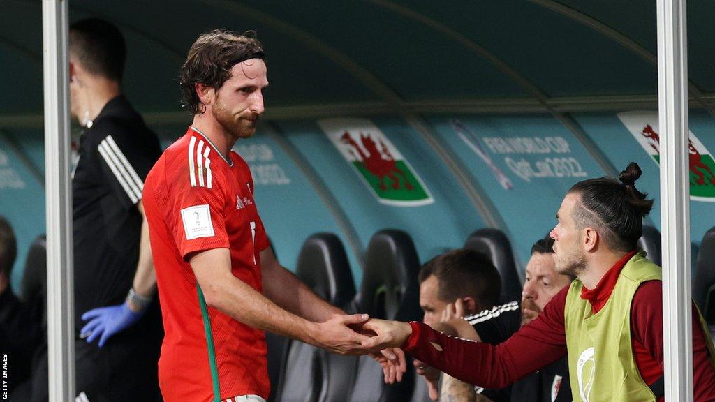 Joe Allen shakes hands with Gareth Bale after being substituted during the World Cup loss to England