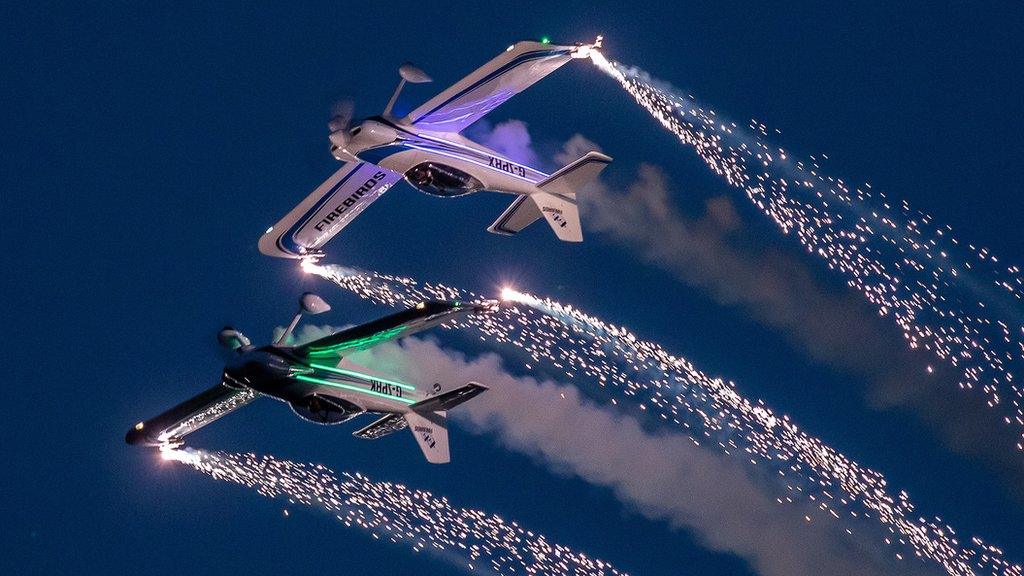 Firebird aircraft at night with fireworks