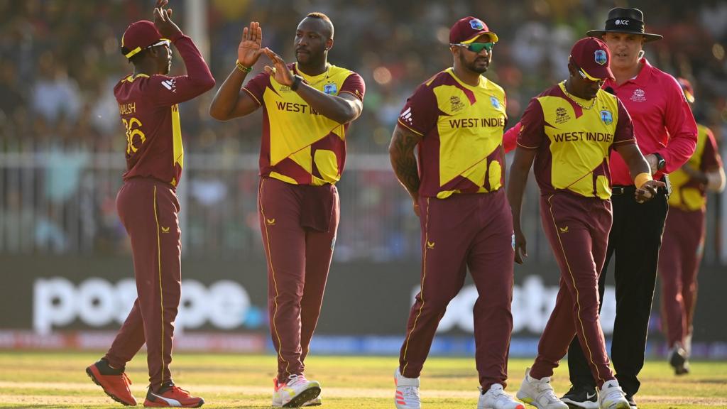 West Indies players celebrate taking a wicket