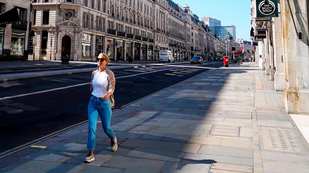 Woman in an otherwise deserted Regent St, London