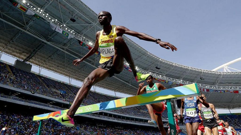 Benjamin Kiplagat leaps over a hurdle during the steeplechase at the Rio Olympics.