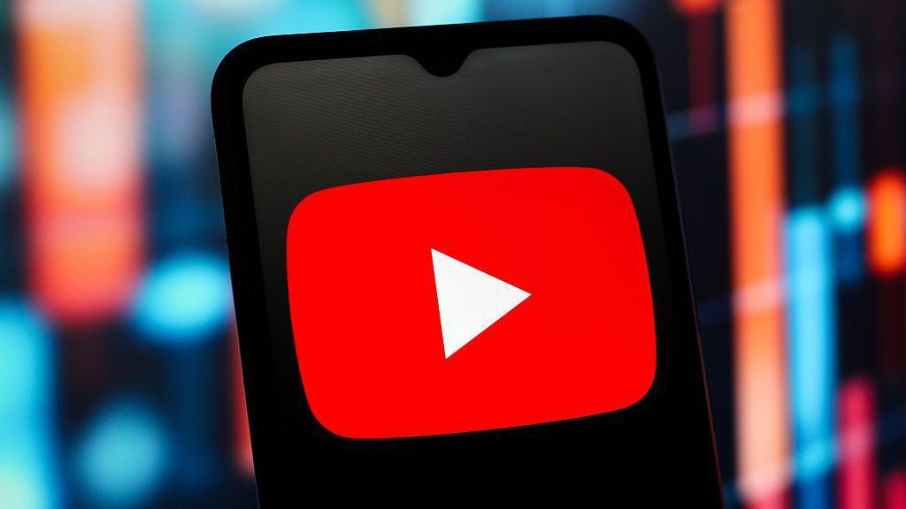 YouTube logo shown on phone screen