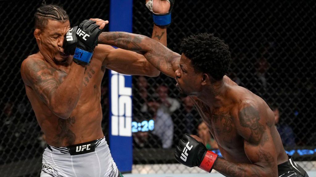 Kevin Holland lands a punch straight on the face of Alex Oliveira