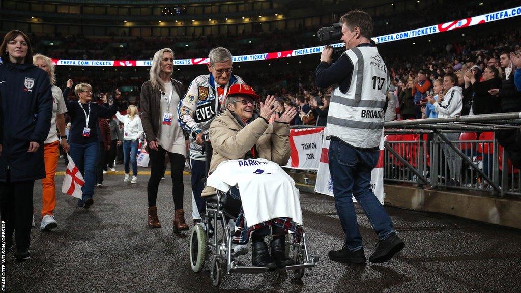 Former England Women players from the 1972 squad carry their honorary match caps and wave to the crowd at Wembley last month