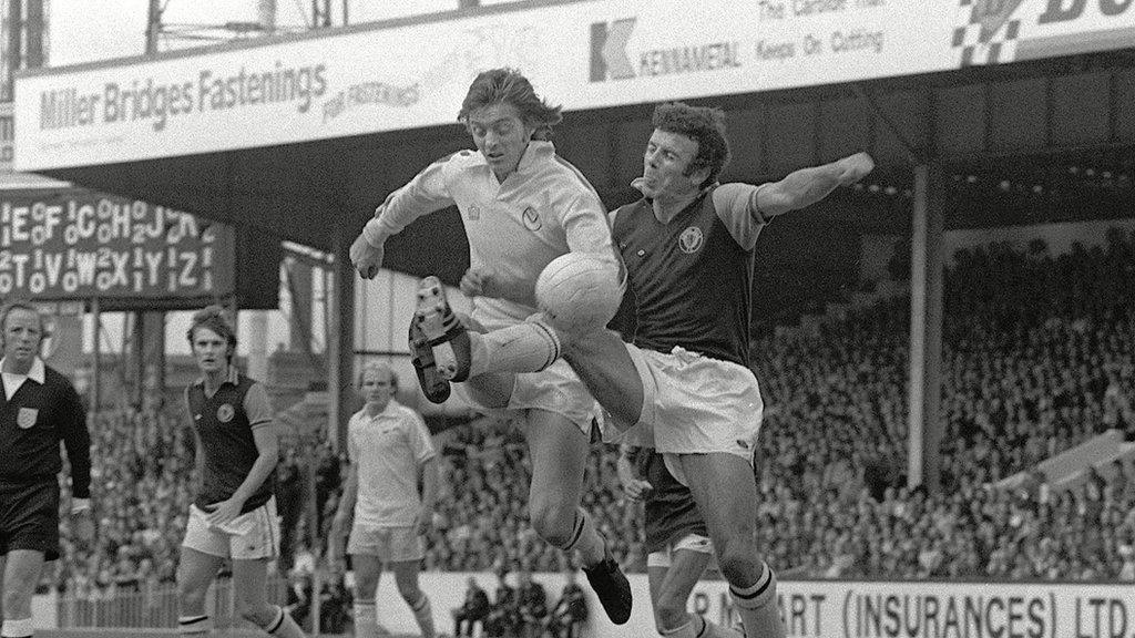 Charlie Aitken tangles with Leeds United's Allan Clarke at Villa Park in 1975