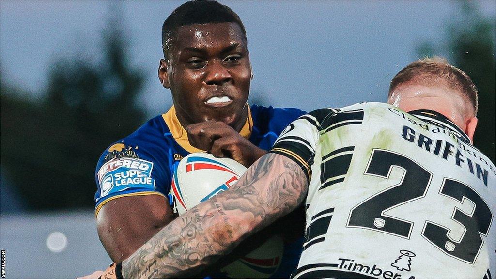 Sam Eseh is tackled by Josh Griffin playing for Wakefield against Hull