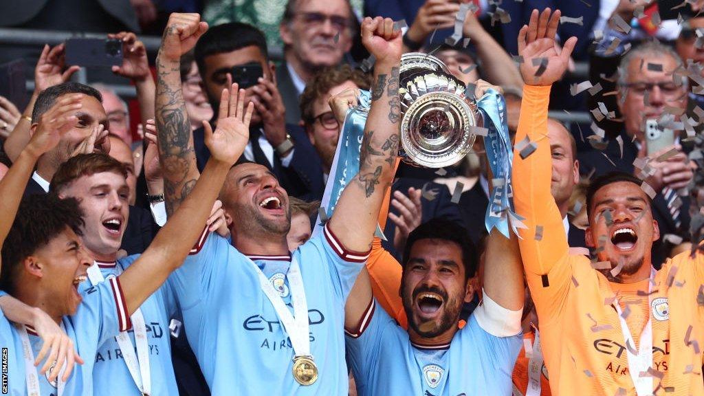 Manchester City players celebrate with the FA Cup