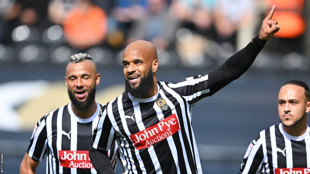 David McGoldrick (centre) thrusts his arm in the air as he celebrates a goal for Notts County