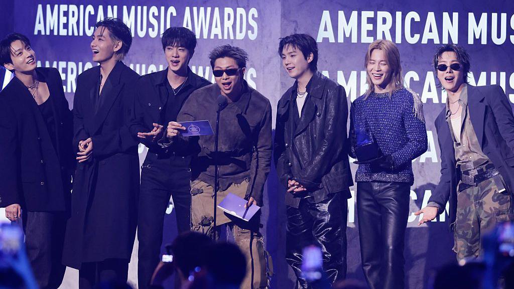 its on stage accepting an award at the American music awards