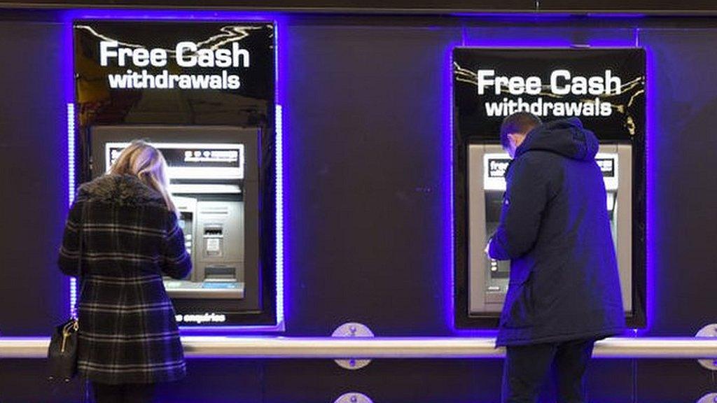 People using cash machines