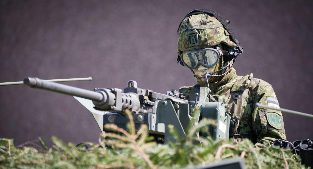 An Estonian soldier is seen in a camouflaged armoured personnel carrier in Tapa, Estonia on 20 May 2023.