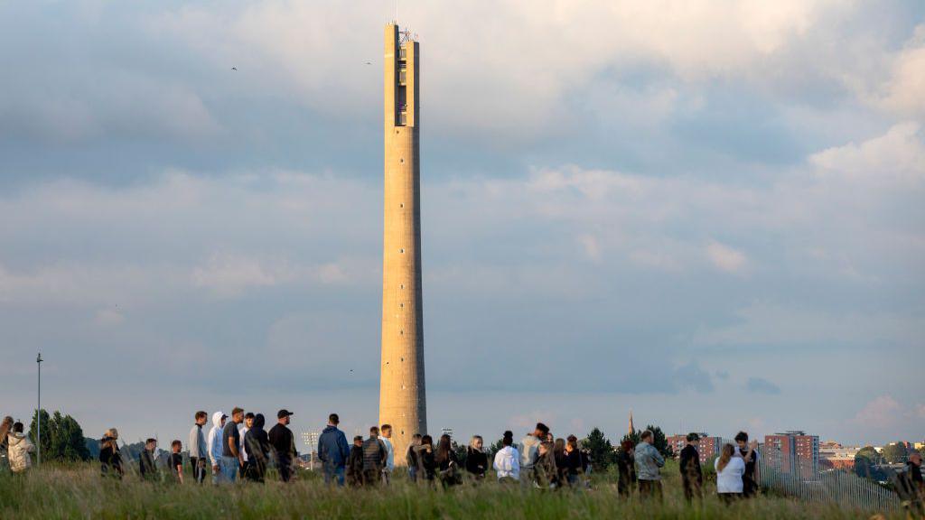 The National Lift Town behind a group of fans outside Sixfields Stadium