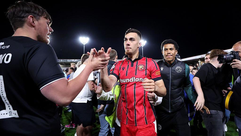 Taylor Allen of Walsall celebrates victory with fans