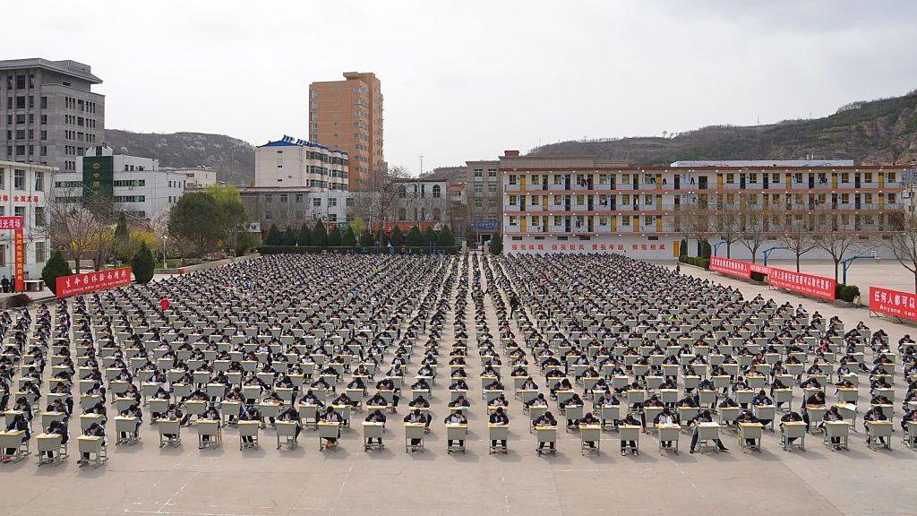 More Than 1,700 students of Yichuan Middle School take an outdoor exam at the playground on April 11, 2015 in Yan'an, Shaanxi province of China.
