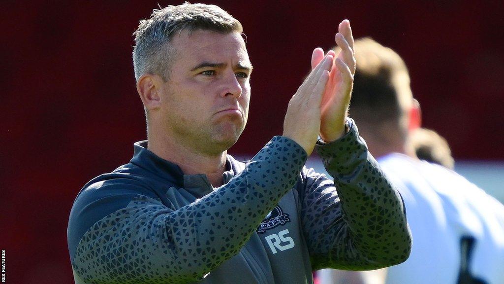 Plymouth Argyle manager Steven Schumacher claps towards some fans