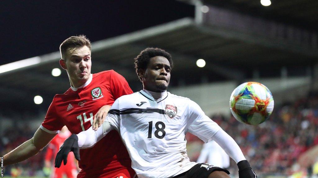 Wales' Ryan Hedges in action against Tristan Hodge of Trinidad and Tobago