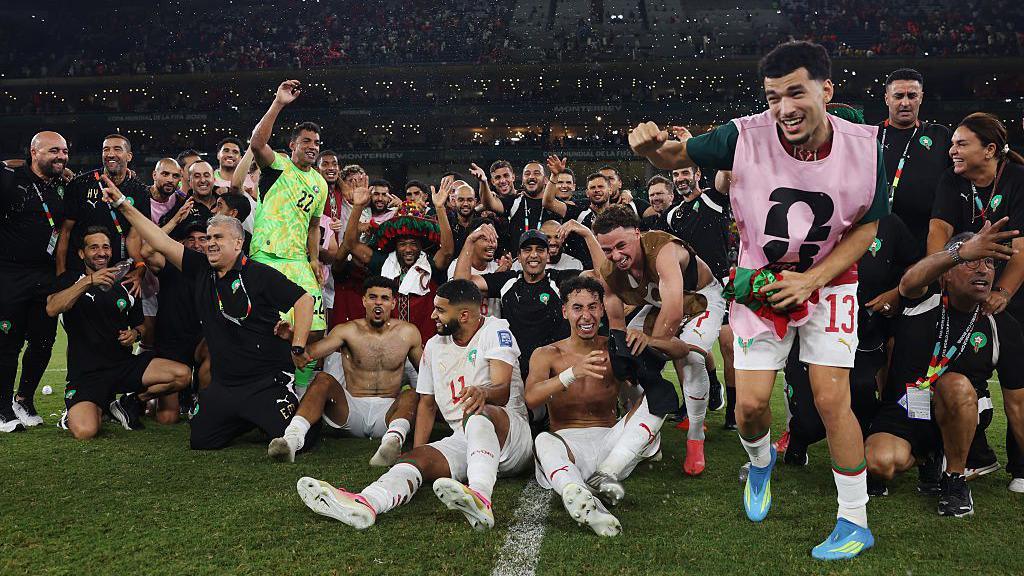 Morocco players celebrate after beating the Netherlands on penalties