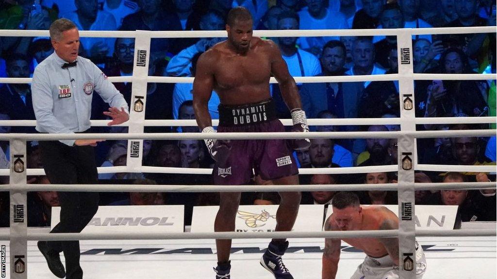 Oleksandr Usyk winces in pain as Dubois watches on