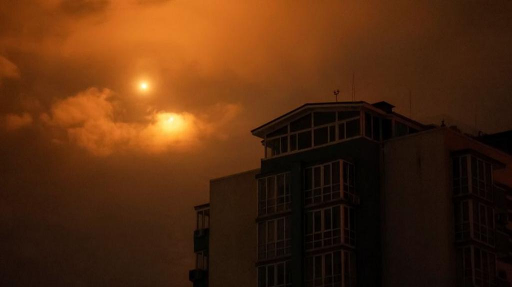 Explosions are seen in the night sky as Ukrainian servicemen fire towards drones during a Russian drone strike, amid Russia's attack on Ukraine