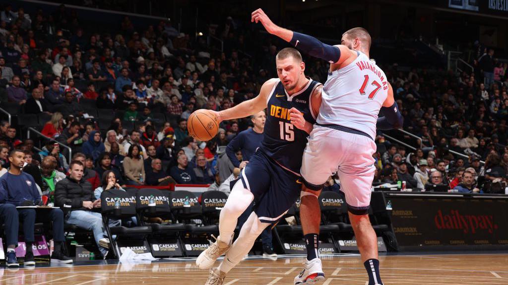 Nikola Jokic dribbles with the ball