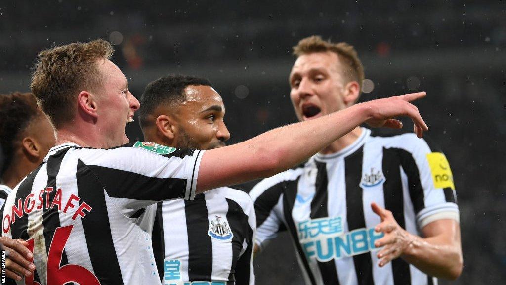 Sean Longstaff celebrates with Dan Burn and Callum Wilson