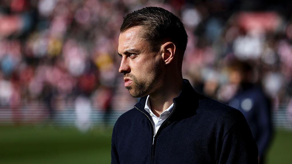 Tonda Eckert looks on from the sidelines