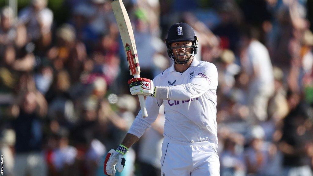 England batter Ben Foakes raises his bat to the crowd after reaching his fifty