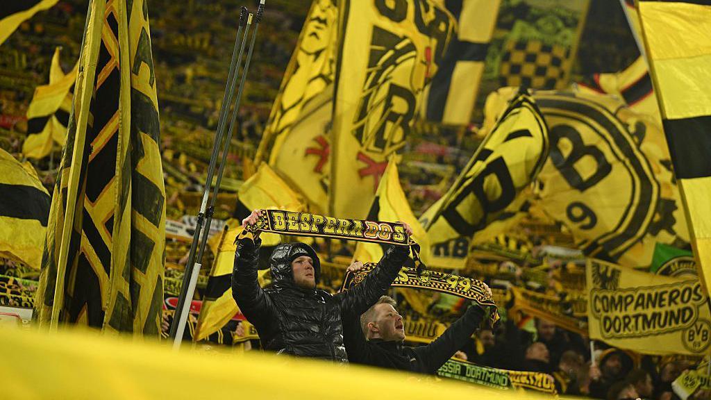 Borussia Dortmund fans wave their scarves